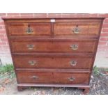 An 18th century cross banded oak straight front chest of 2 short over 3 long cock beaded drawers,