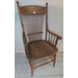 An Arts & Crafts oak stick back open sided armchair in the American taste.