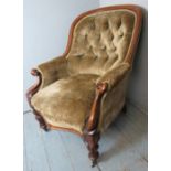 A Victorian carved oak show-wood framed, button back armchair in re-upholstered green velvet.