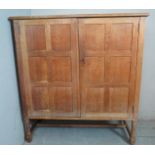 An early 20th century British Arts & Crafts figured oak side cabinet,