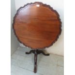 A Georgian mahogany tilt top 'birdcage' side table featuring a carved scalloped Chippendale border,