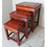 A Chinese hardwood nest of 3 graduated occasional tables in a period style,