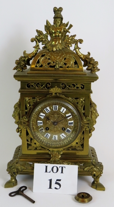 An ornate French brass mantle clock by J