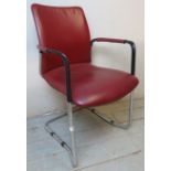 A vintage metal framed chair upholstered