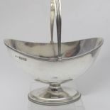 A silver sugar basket with swing handle,