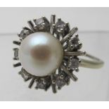 An unmarked white metal pearl and diamon