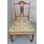 A Edwardian occasional chair with ornate