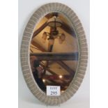 A vintage Lloyd Loom style oval mirror w