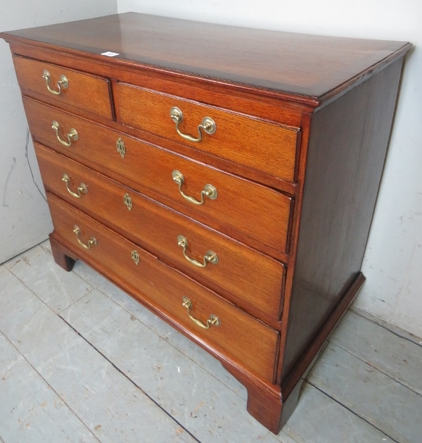 A Georgian oak chest of two short over t