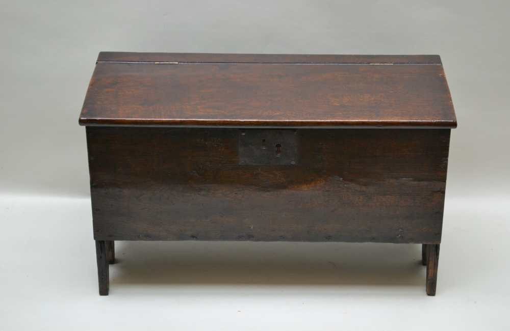 A 19TH CENTURY SMALL SIX PLANK COFFER with three-quarter lift-up lid, having vacant interior, the