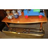 A TEAK FINISHED RECTANGULAR ELIPTICAL RETRO COFFEE TABLE, supported on four plain tapering