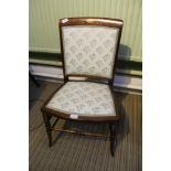 AN EDWARDIAN MAHOGANY SINGLE CHAIR with inlaid crest rail, upholstered back and seat pad,