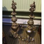 A PAIR OF CAST BRASS CLASSICAL FIRE DOGS together with two brass toasting forks