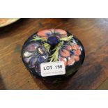 A MOORCROFT FLORAL DECORATED LIDDED POT