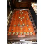 A VINTAGE TABLE TOP BAGATELLE BOARD, model Corinthian 24, together with a boxed set of turned wooden