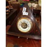 AN OAK BEADED TRIANGULAR WALL MOUNTED BAROMETER