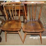 THREE ERCOL STICK BACKED SOLID SEATED CHAIRS