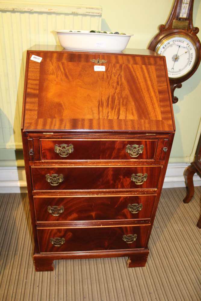 A REPRODUCTION MAHOGANY FINISHED SLENDER SIZED BUREAU with well fitted interior, having four full