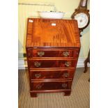 A REPRODUCTION MAHOGANY FINISHED SLENDER SIZED BUREAU with well fitted interior, having four full