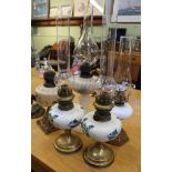 A PAIR OF BRASS BASED POTTERY RESERVOIRED OIL LAMPS together three others