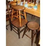 A FOUR RUNG LADDER BACK CHAIR with solid seat, together with TWO FOUR LEGGED STOOLS, one circular