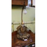 A DECORATIVE PORCELAIN MODEL SEATED SAMURAI on carved wooden plinth base, with electric lamp