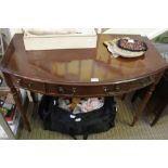 A REPRODUCTION MAHOGANY FINISHED BOW FRONT SIDE TABLE having three inline drawers, supported on