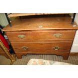 A PITCHED PINE LOW TWO DRAWER CHEST supported on bracket feet