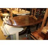 A MAHOGANY FINISHED OVAL TOPPED CENTRE TABLE with reeded edge, supported on a turned single
