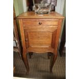 A FRENCH OAK BEDSIDE CUPBOARD, with marble top, fitted drawer and ceramic lined cupboard, raised