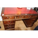 A REPRODUCTION MAHOGANY TWIN PEDESTAL DESK, of typical form and construction, with red coloured
