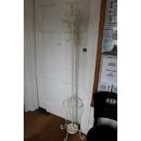 AN IVORY WHITE PAINTED METAL FREE-STANDING HAT, COAT & STICK STAND