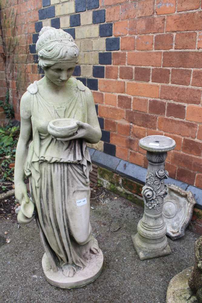 A WEATHERED CAST CONCRETE GARDEN STATUE OF A GRECIAN FEMALE together with a bird bath with rose