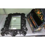 A BLACK FINISHED CARVED & PIERCED WOODEN FRAMED MIRROR together with a floral decorated possibly