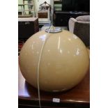 A 1970s RETRO HEAL'S PENDANT CEILING LIGHT having globular cafe au lait coloured shade