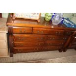 A PROBABLE FRENCH WOODEN DOUBLE WIDTH CHEST OF NINE DRAWERS, having reeded side supports