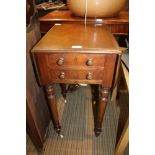 A 19TH CENTURY MAHOGANY FINISHED TWIN FLAP TOPPED WORK TABLE with two slender drawers, supported