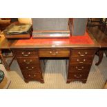 A REPRODUCTION MAHOGANY FINISHED TWIN PEDESTAL DESK with skiver insert top, having two purpose built