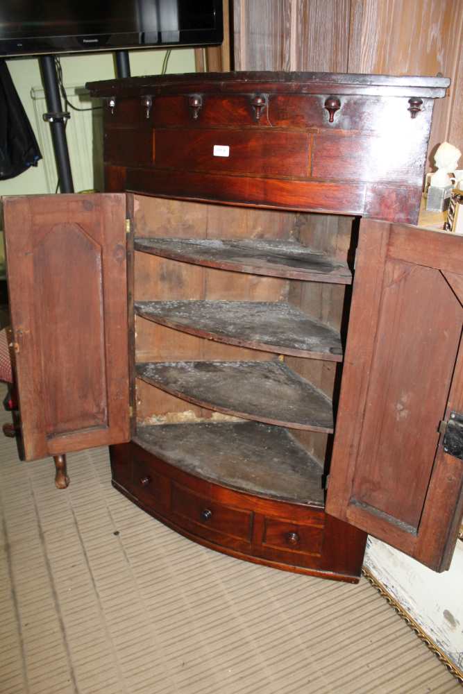 A 19TH CENTURY LARGE BOW FRONT HANGING CORNER CUPBOARD with twin plain panel doors, revealing - Image 2 of 2