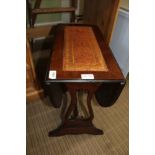 A REPRODUCTION MAHOGANY COLOURED TWIN FLAP COFFEE TABLE, with skiver insert tops, supported on