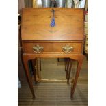 A GOOD QUALITY WALNUT COLOURED LADIES WRITING CABINET with plain fall down front, revealing