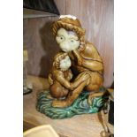 A PAINTED ORIENTAL CAST POTTERY FIGURE OF A MONKEY AND HER CHILD