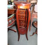 A MAHOGANY CIRCULAR TOPPED JARDINAIRE STAND on four S shaped legs united with a circular undertier