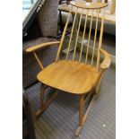 AN ERCOL STYLE ROCKING STICK BACK ARMCHAIR with solid seat