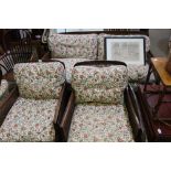 A FIRST QUARTER 20TH CENTURY MAHOGANY FRAMED BERGERE THREE PIECE SUITE, with quality rose,