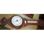 A CARVED OAK BACKED WALL MOUNTABLE BAROMETER THERMOMETER