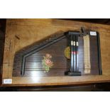 A WOODEN ZITHER complete with tuning key