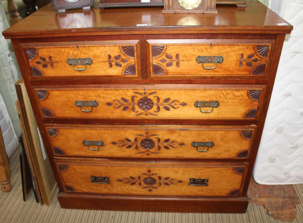 A LATE 19TH CENTURY WALNUT & STAINWOOD CARVED FRONT CHEST OF FIVE DRAWERS having two inline and