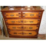 A LATE 19TH CENTURY WALNUT & STAINWOOD CARVED FRONT CHEST OF FIVE DRAWERS having two inline and