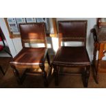 A SET OF FOUR OAK FRAMED CROMWELLIAN STYLE DINING CHAIRS later brown leather upholstered with